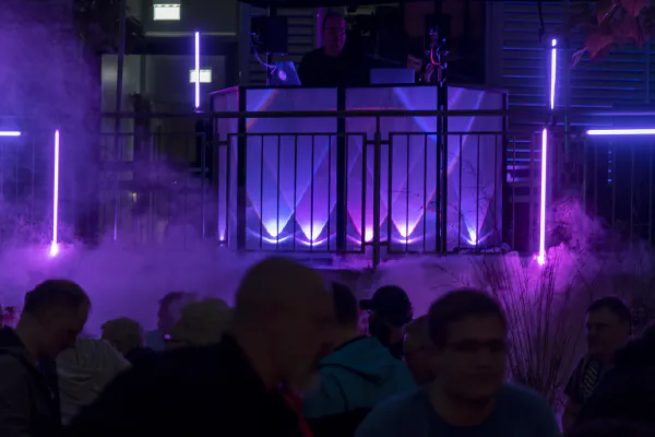 DJ booth with light and fog effects at night at the Social Event.
